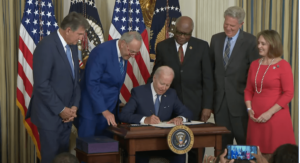 President Biden signing the Inflation Reduction Act